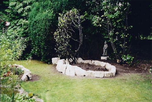 The stones in place around the first new bed